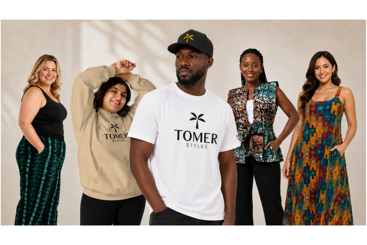 Five models wearing TOMER STYLES apparel, including a white graphic t-shirt, a beige hoodie, a patterned top, and a colorful dress, posed against a neutral beige background.